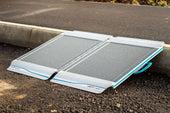 Lightweight portable kerb ramp for crossing from pavement to road, shown in side view.