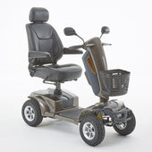 Bronze Xcite mobility scooter with 4 wheels, black seat, armrests, basket and mirrors, shown from front angle.