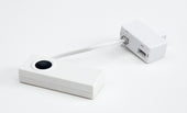 White Telephone Signaller Transmitter with black button and adapter, shown on a white background, front view.