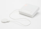 Small white sound sensor transmitter with circular sensor and red LED on top, shown in front view.