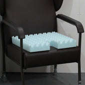 Light blue foam wheelchair cushion with raised nodules and a cut-out at the back for the coccyx, angled view.