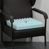 Harley Proform Combi Cushion on a black wheelchair with armrests, for pressure relief, room setting, side view.