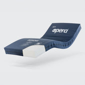 Blue and white castellated foam profiling mattress on a plain white background, angled front view.