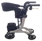 Metallic silver rollator with four wheels, hand brakes, basket and padded seat, side view.