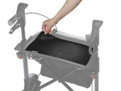 Hand lifting Topro anti-slip mat for tray, used with mobility aids, close-up in use.