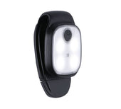 Black clip-on LED lamp with oval front and top power button, designed for rollators, close-up view.