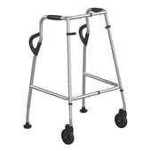 Lightweight silver walking frame with swivel castors at the front, black hand grips and rear rubber tips, front view.