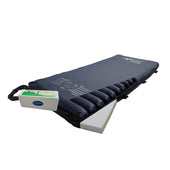 Apollo 5 Plus dynamic replacement mattress system for pressure care, shown on a standard bed frame, angled side view.