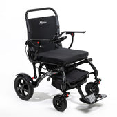 Black carbon fibre folding powerchair with joystick, cushioned seat, armrests and storage pouch, side view.