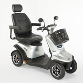 Silver 4-wheel mobility scooter with padded seat, armrests and front basket, front angle view.