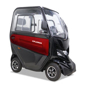 Red Motion Healthcare Xplorer mobility scooter with a compact enclosed cabin on a white background, front view.