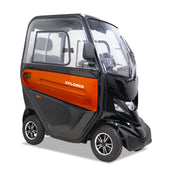 Orange Xplorer three-wheeled mobility scooter, enclosed design, compact size, front side view.