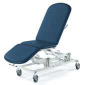 SEERS Medical Sterling Electric 3 Section Couch with electric height adjustment and wheels, angled view.