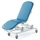 SEERS Medical Sterling Electric 3 Section Couch with wheels and electric height adjustment, white background, angled view.