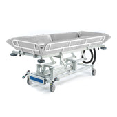 SEERS Medical Electric Shower Trolley with side rails and wheels for patient transport and hygiene care, side view.