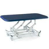 Dark blue SEERS Medical electric therapy mat table with height adjustment, white scissor-lift frame and wheels, side view.