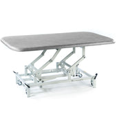 SEERS Medical Electric Therapy Mat Table, height-adjustable with padded top and metal frame on wheels, side view.