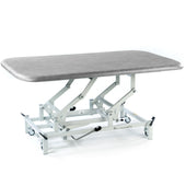 SEERS Medical Hydraulic Therapy Mat Table with height-adjustable top and white wheeled frame, side view.
