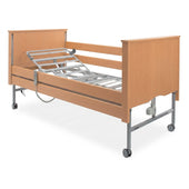 Sidhil Bradshaw Nursing Care Bed with wooden headboard, metal frame and wheels, designed for nursing care needs, front view.