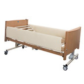 Sidhil Bradshaw full-length side rail pads fitted to hospital bed with wooden frame, wheels, and protective cover, side view.