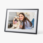 Relish digital photo frame showing a smiling woman with her Labrador indoors, in use.