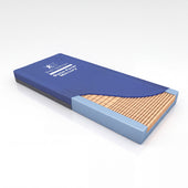 Direct Healthcare Dyna-Form Mercury Mattress with cover off, showing grid castellated foam and side edges, angled view.