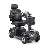 Drive Envoy 8 Scooter with padded seat, armrests, headrest and front basket on four wheels, side view.