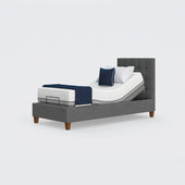 Flyte Adjustable Bed with Zero Gravity feature, white bedding, navy blanket, two pillows, front view.