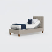 Opera Beds Flyte Adjustable Bed with Zero Gravity, raised headrest, white mattress, blue blanket and pillows, front view.