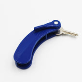 Key turner holding two metal keys with an easy-grip handle, designed for turning keys easily, shown in close-up.