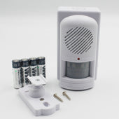 Easy Link motion activated memo reminder with buttons and speaker, shown with mounting hardware and AA batteries, front view.