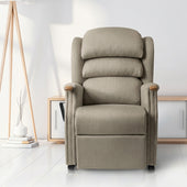 Natural Henley Dual Motor Riser Recliner Chair in a living room with white walls and wood accents, angled front view.