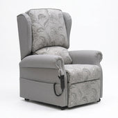 Repose Westbury dual motor riser recliner chair with floral fabric, split back and wired remote, front view.