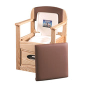 Royale Flushing Commode by Gordon Ellis, wooden chair with armrests, seat and cushion, built-in portable toilet and storage drawer, front view.