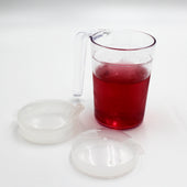 Homecraft Shatterproof Mug with handle, filled with liquid, shown with two anti-spill lids on white background, front view.