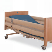 Sidhil Side Rail Mesh Pads pair fitted on bed with wooden frame, mattress, side rails, and wheels, white background, angled view.