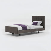 Opera Beds Signature Comfort Profiling Bed with leatherette frame, white bedding and purple accents, side view.