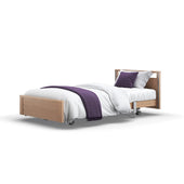 Opera Beds Signature Low Footboard Profiling Bed with white bedding, purple blanket and pillows, on wheels, isolated on white, front view.