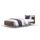Opera Beds Signature Low Footboard Profiling Bed with white bedding, purple throw, pillows and wheels, front view.
