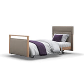Signature Upholstered Profiling Bed with white bedding and purple accents on a plain background, front view.