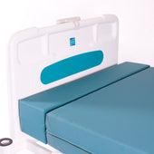 Softrest Mattress Extension by Sidhil attached to a hospital bed headboard, side view.