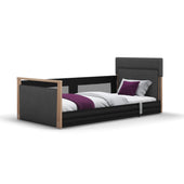 Opera Beds Solo SafeSide Profiling Floor Bed with grey headboard, white bedding, purple blanket and two pillows, front view.