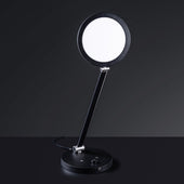 The Daylight Company TriSun Therapy Lamp with adjustable brightness, circular light, and adjustable arm on round base, side view.