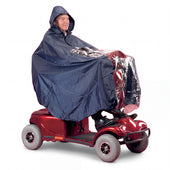 Man on a mobility scooter wearing a Homecraft Universal Scooter Cape with a clear front panel, side view.