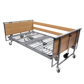 Harvest Healthcare Woburn Community 1200 bed with metal frame, wood ends, side rails and wheels, front angle view.