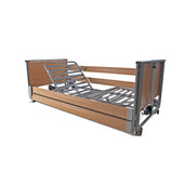 Woburn Community Low Bed with wood panels, raised headrest and safety side rails, front angle view.