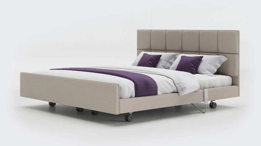 Stylish beige bed with tall tufted headboard, white linens, purple and white pillows; minimal design on plain white background.