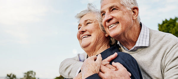 elderly couple hugging in nature Image