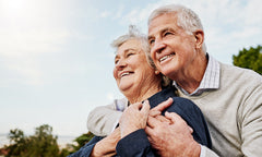 elderly couple hugging in nature