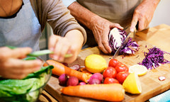 elderly couple preparing food at home